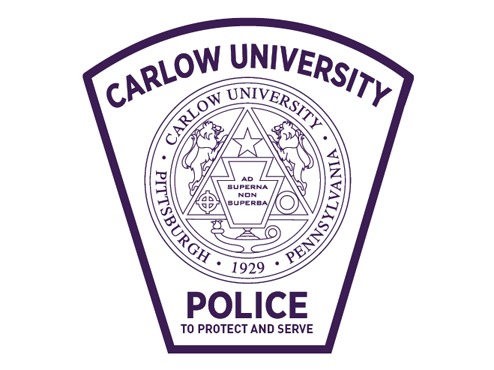 A badge has the words Carlow University at the top and Police at the bottom, surrounding the Carlow University seal.