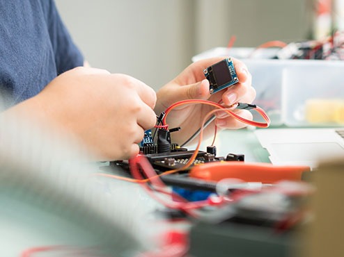 A young student works on an electronics project in a CREATE Lab.