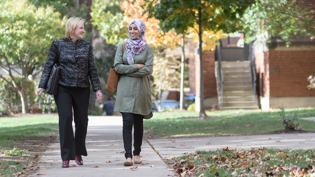 Two women walk outside on the Carlow campus.