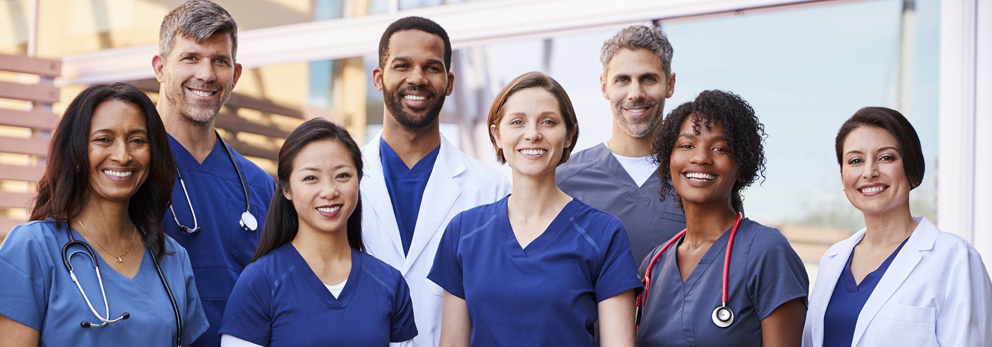 A group of community health workers standing together outside.