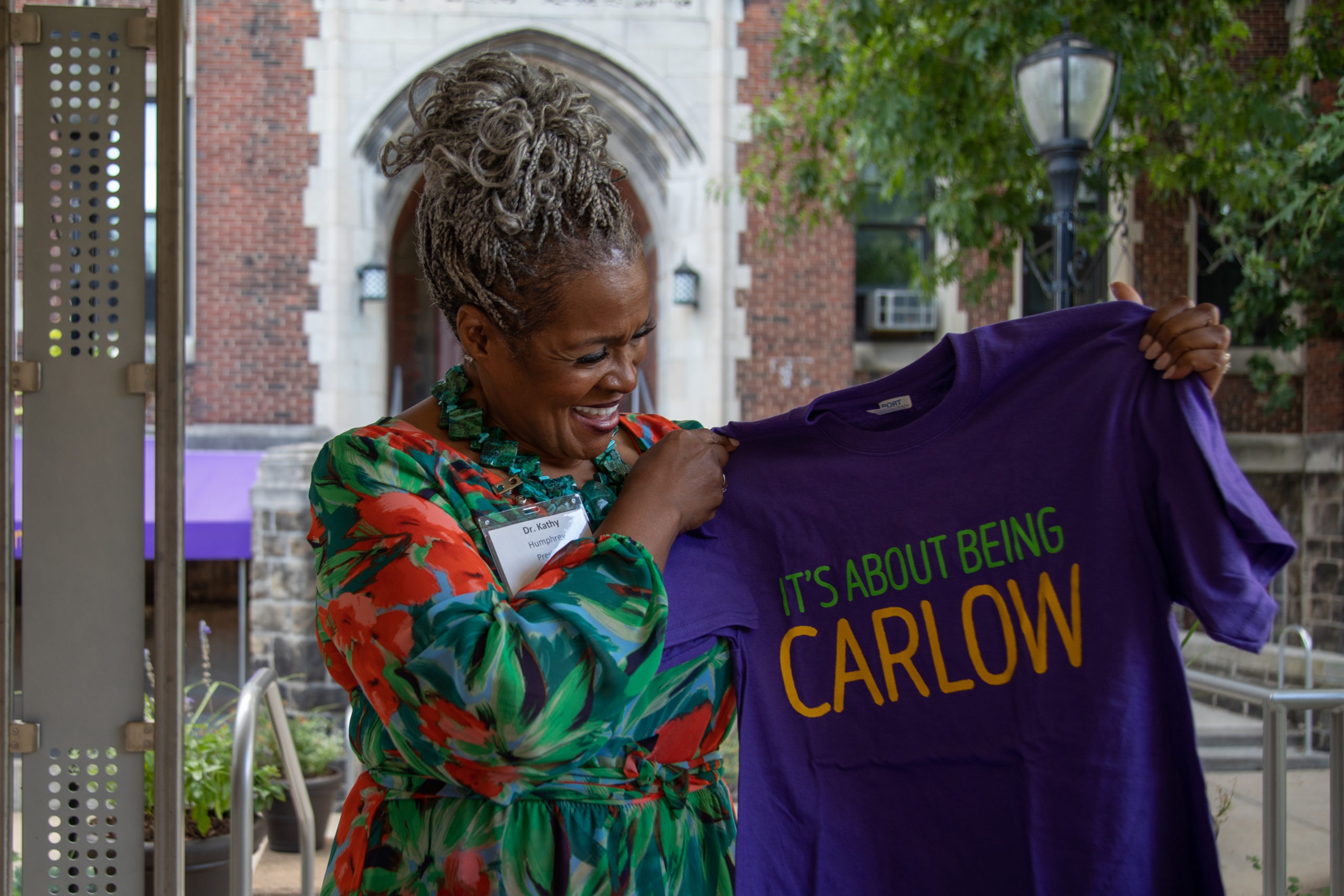 Dr. Humphrey holds a tshirt that reads It's about being Carlow.
