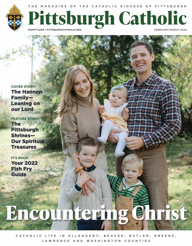 Cover of the February/March issue of the Pittsburgh Catholic. A white, young family is pictured on the front with the headline, Encountering Christ.