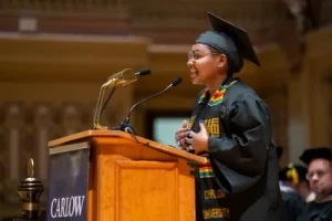 Gabrielle Adams stands at the podium during commencement delivering her speech.