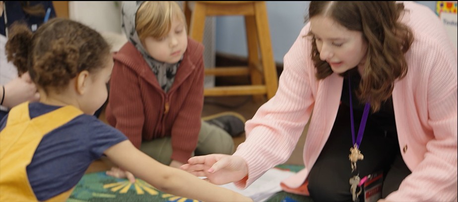 Teacher working with young students