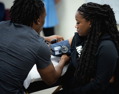Carlow nursing students taking a blood pressure reading