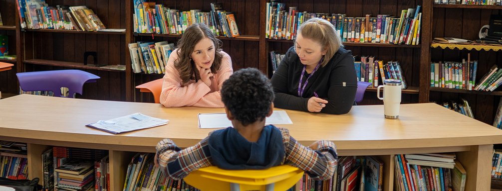 Carlow students tutoring in a library