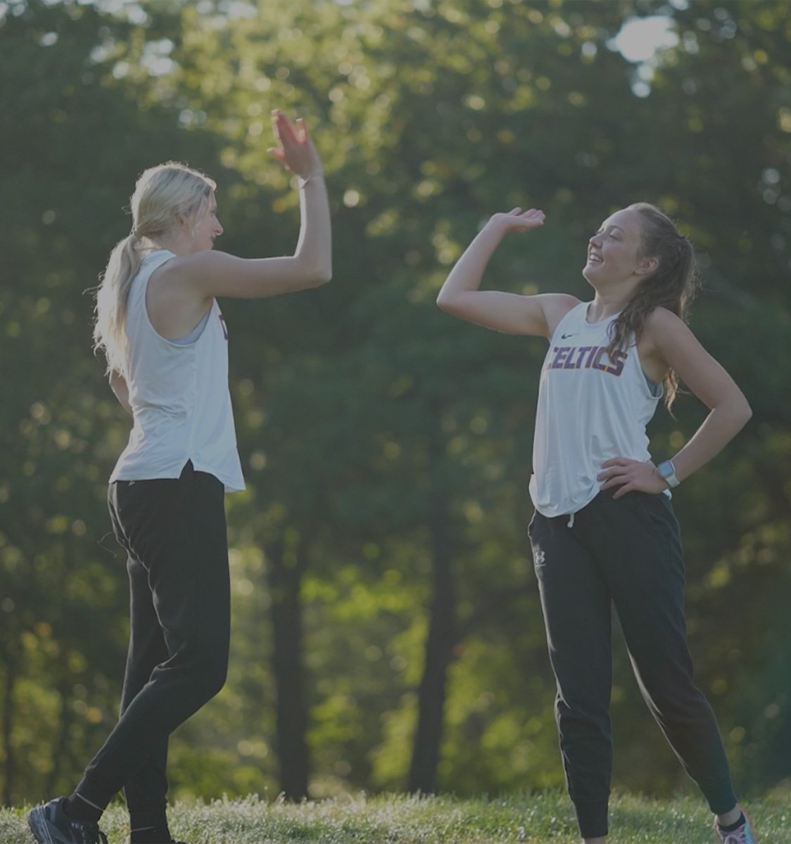 Two Carlow students celebrating outdoors