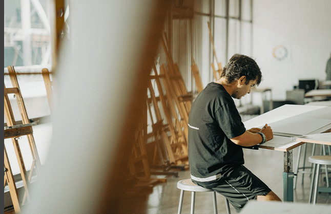 A Carlow student-athlete working in a studio classroom